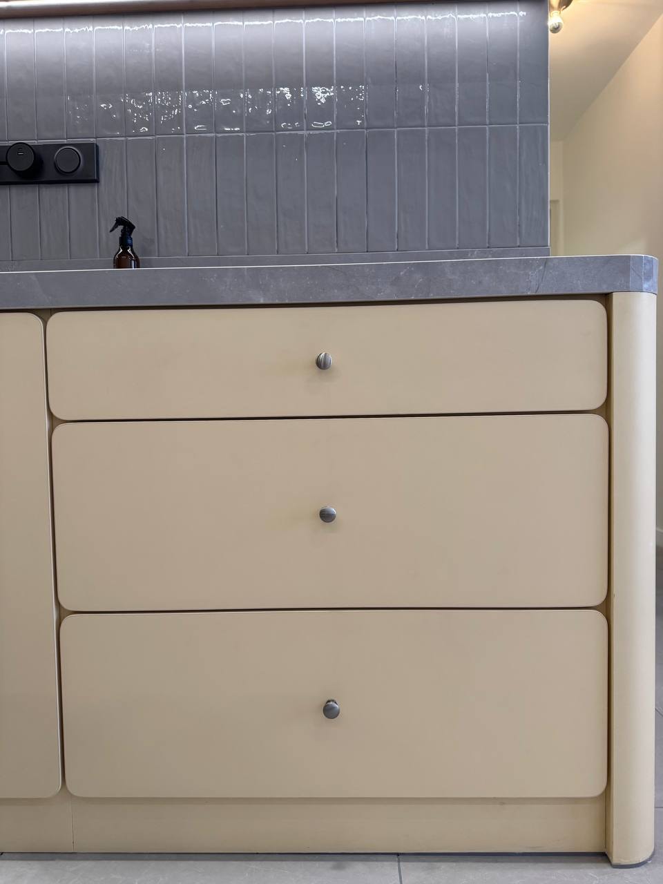 Three-drawer cabinet unit with stone top and tictac tile detail