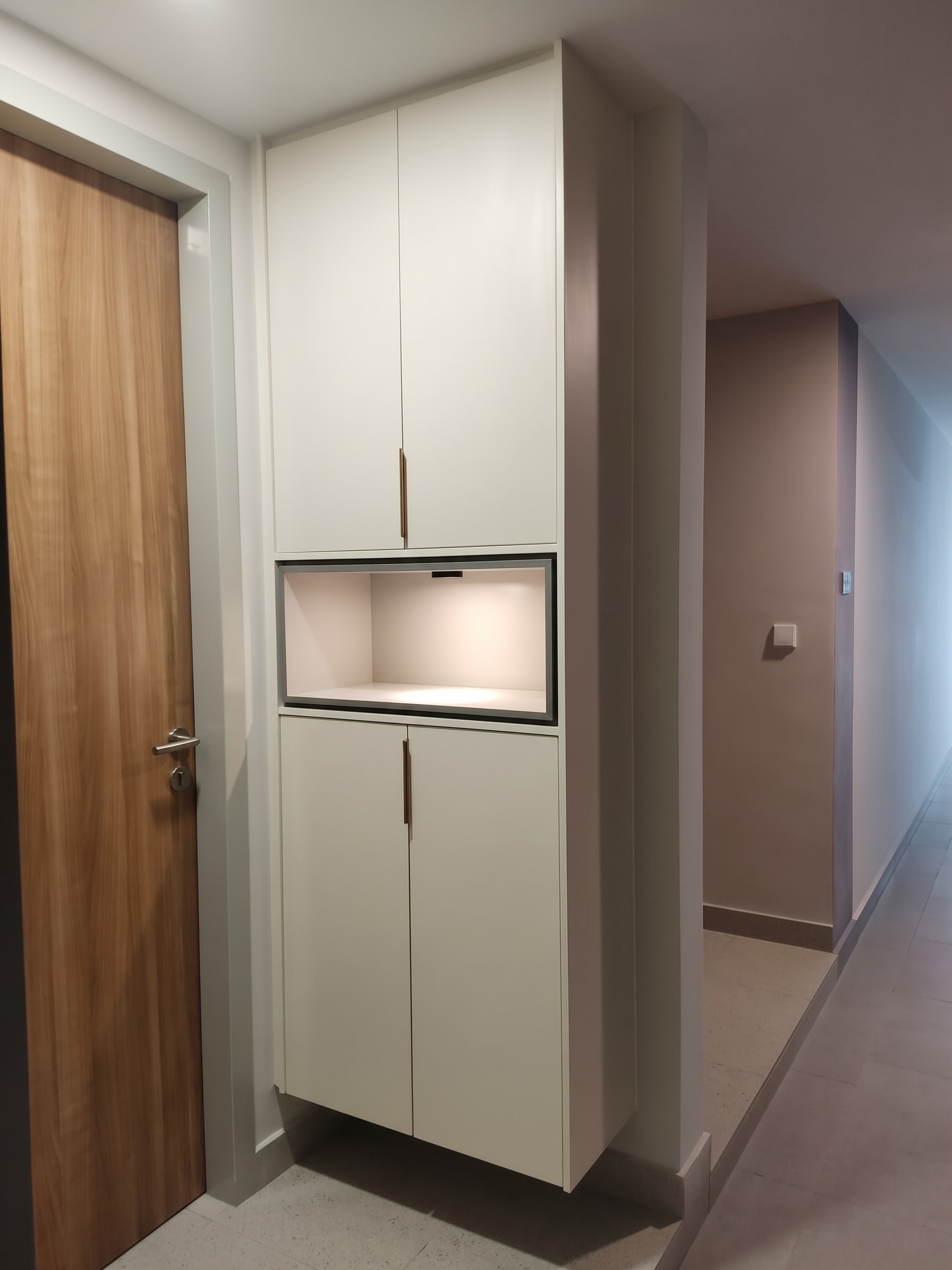 Full-height display cabinet with lit niche and clean-touch panel doors
